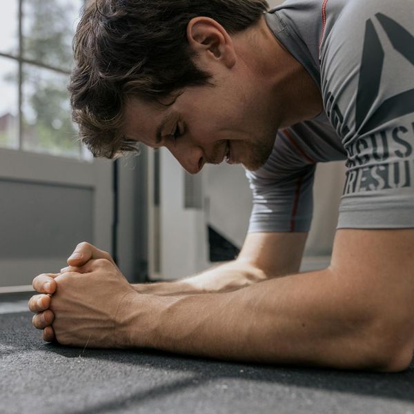 Man in a plank position demonstrating core strength and stability.